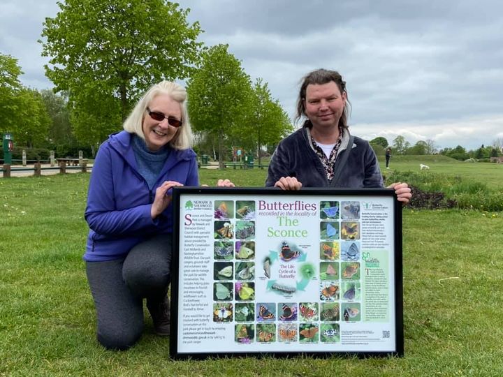 image of Jane and Melanie holding an information panel